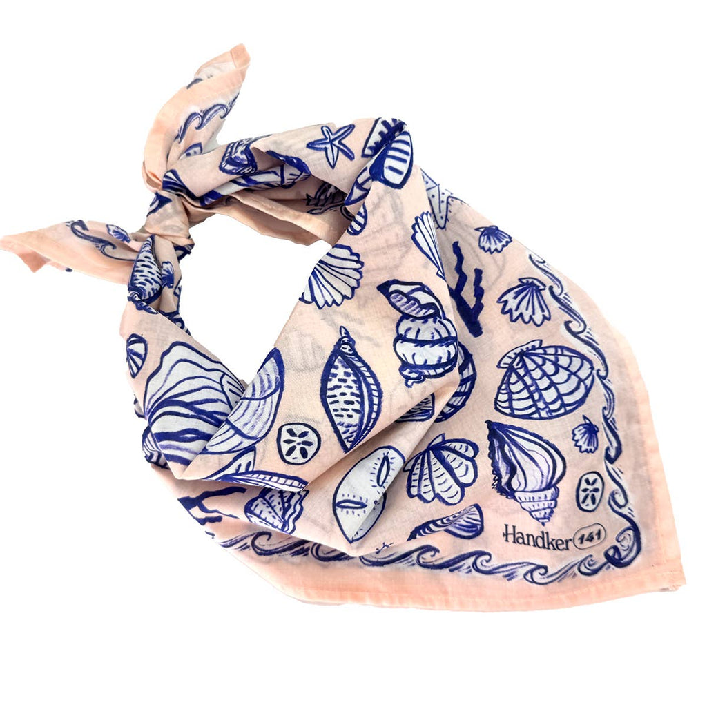 Peachy-pink scarf with a blue sea-themed pattern on a white background