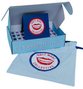 A light blue gift box labeled 'DIRTY MAHII COLLECTIVE' with a matching blue pouch in front, both printed with a red lips logo. Inside the box is a blue card and small packaged items, photographed on a white background.