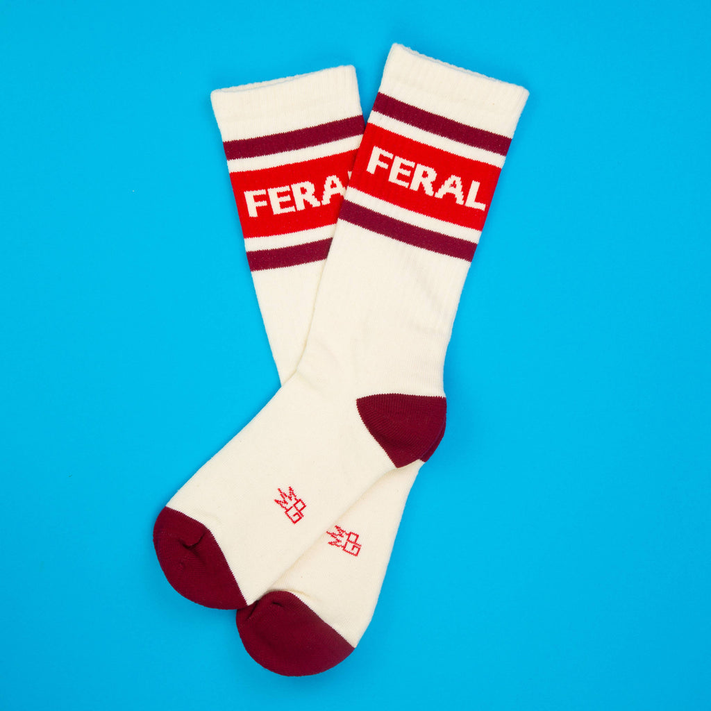 White socks with red accents and 'FERAL' text on a blue background