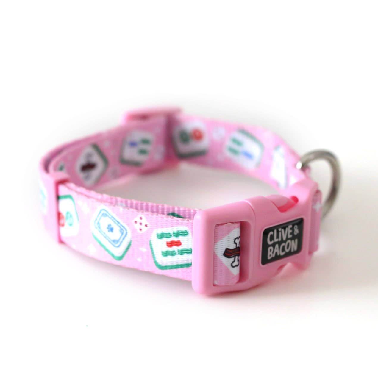 A bright pink dog collar with a pattern of classic mahjong tiles and a black patch that reads 'CLIVE & BACON' finished in white letters.
