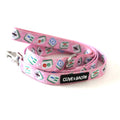A pink pet leash with a repeating pattern of mahjong tiles and a black brand label reading 'CLIVE & BACON', photographed on a white background.