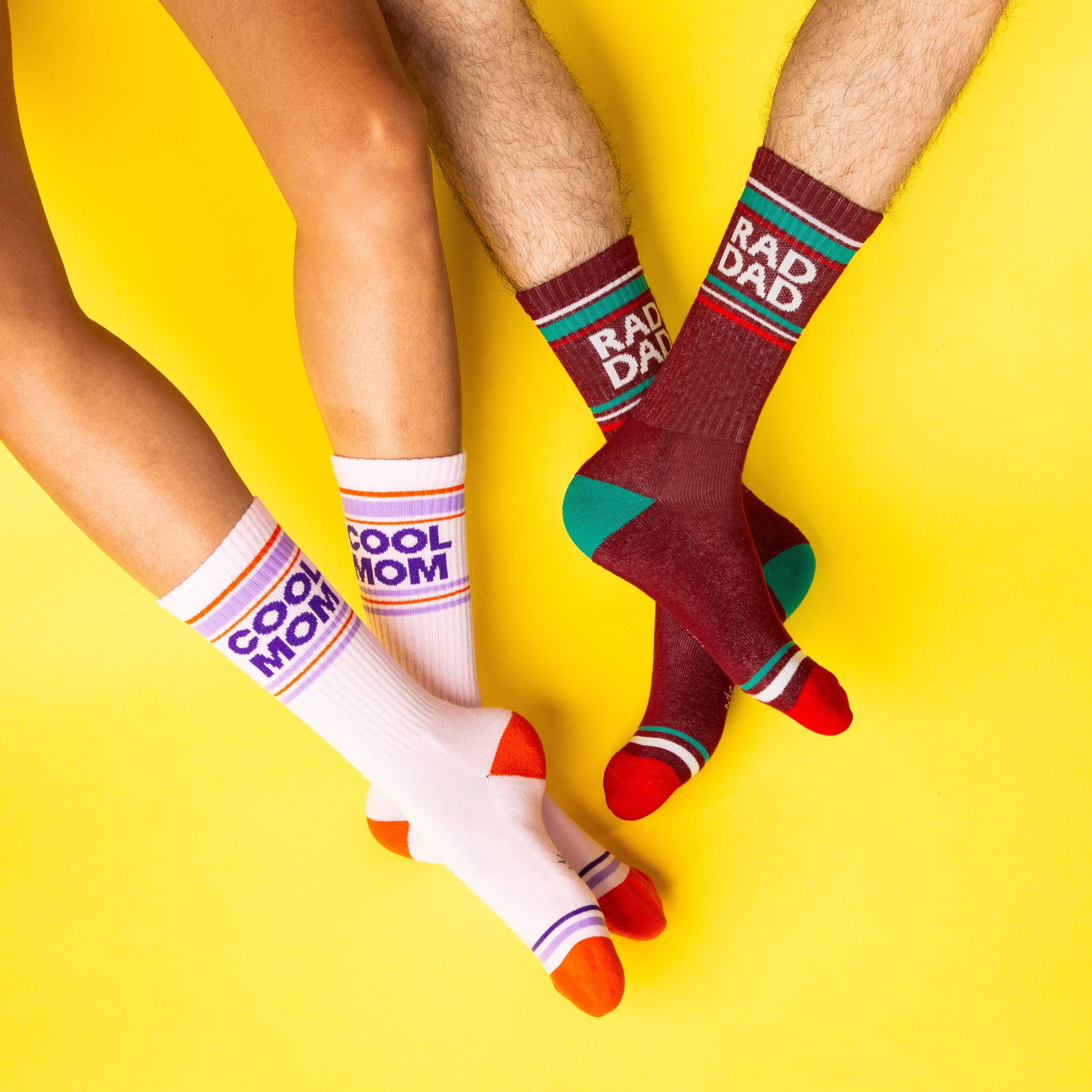 Two pairs of colorful socks with text on a yellow background