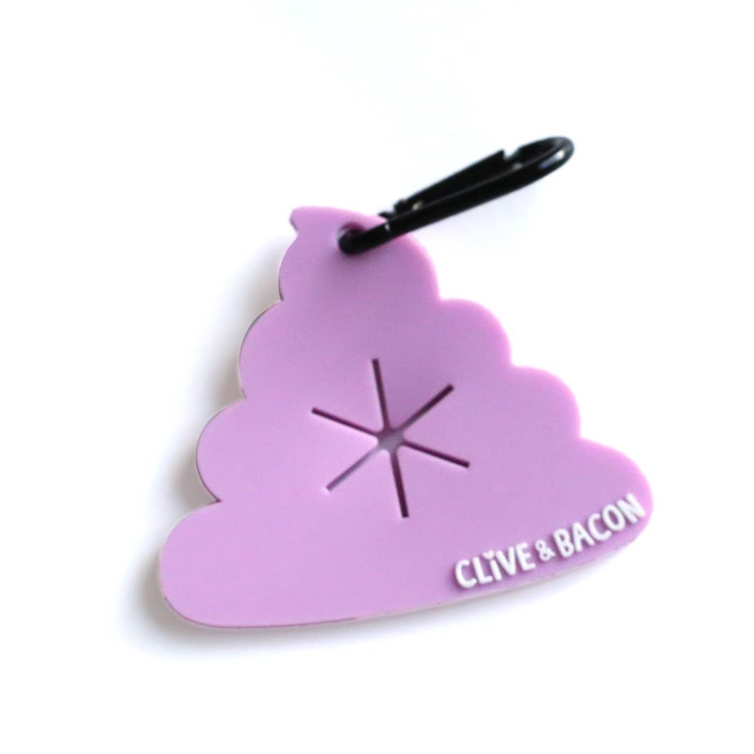 A light purple poop-shaped keychain or bag charm with a black carabiner clip. The center has a starburst cutout, and the bottom right corner features the text 'CLIVE & BACON' in white.