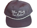 A vintage navybaseball cap with white embroidered text reading 'Who Made The Rules?' on the front, featuring a white patterned trim across the brim, set against a plain white background.